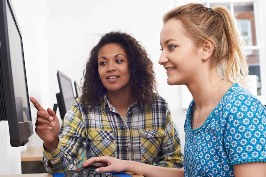 Two women working on a computer