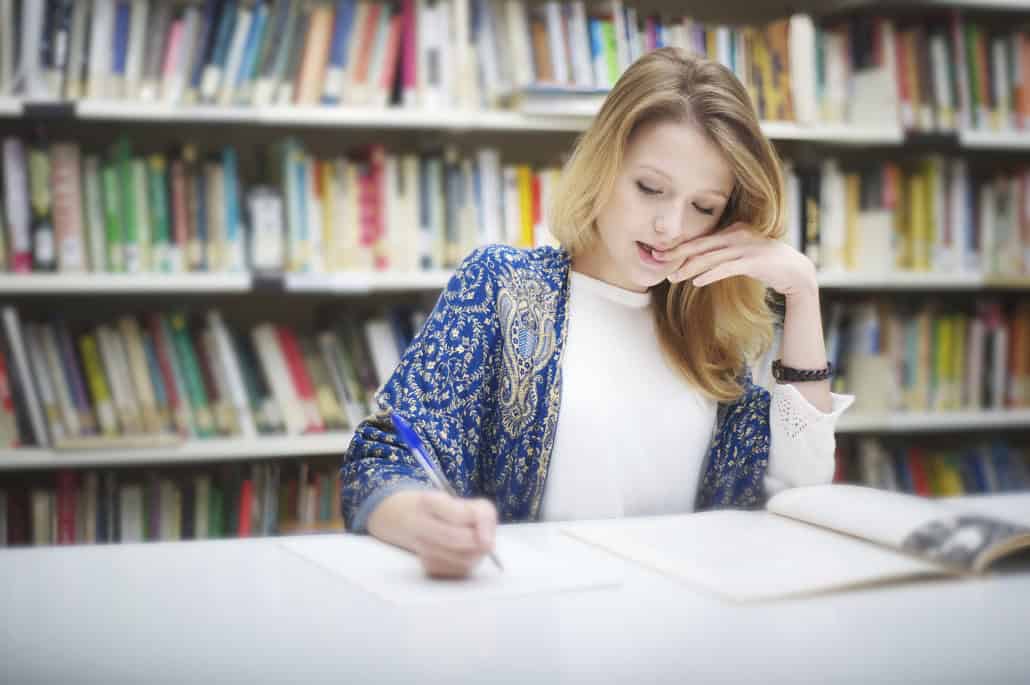 Woman writing in a library