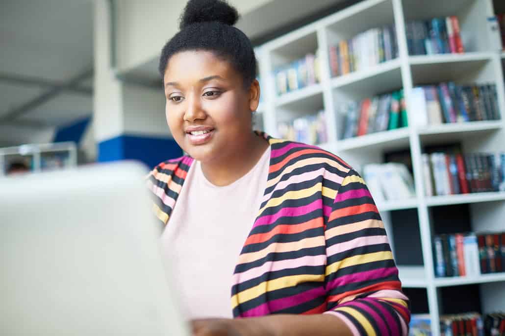 Woman on laptop learning about Attainable