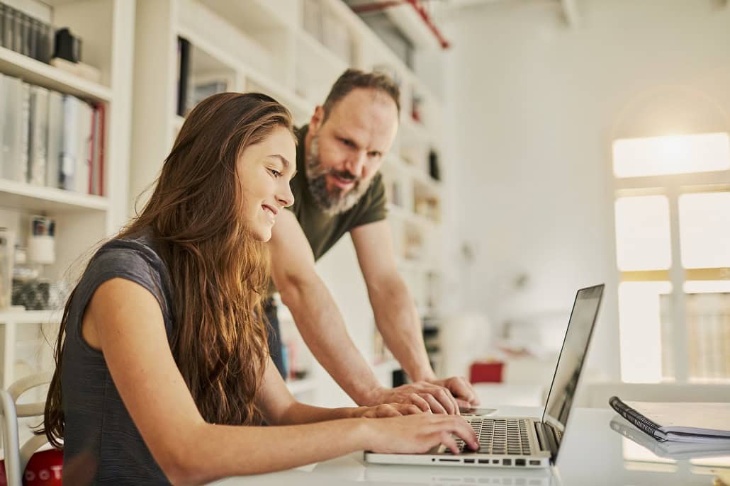 Father and daughter using laptop