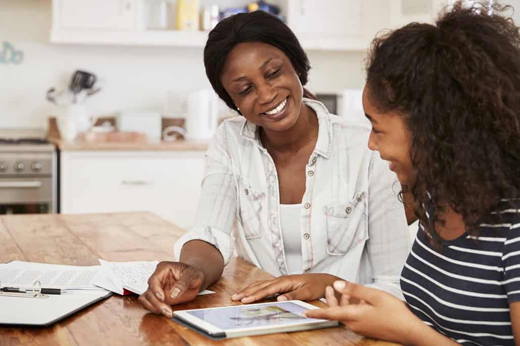 Mother and daughter using laptop