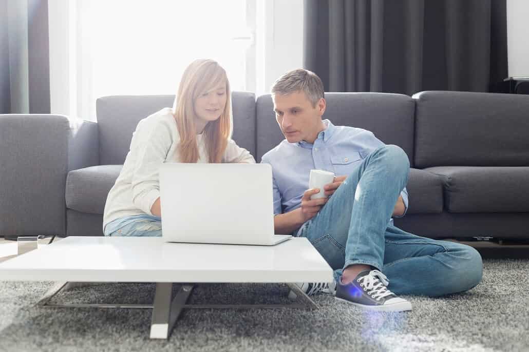 Father and daughter using laptop