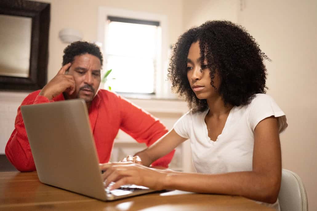 Student and father using laptop