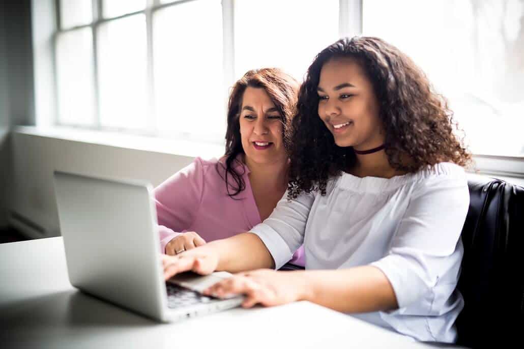 Counselor and student using laptop