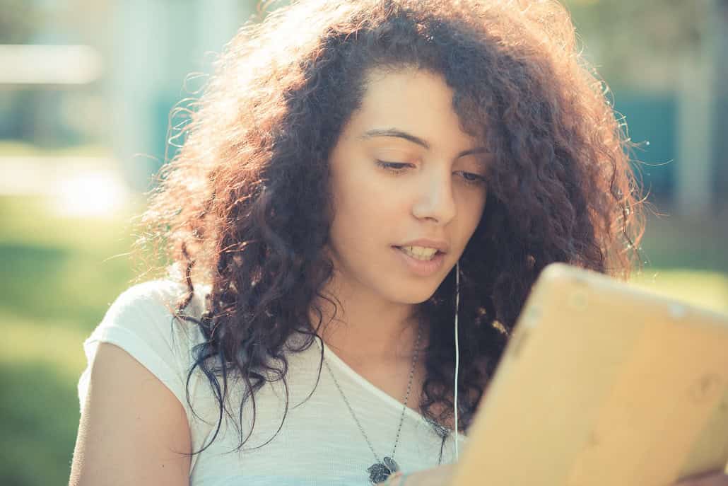 Girl reading about college admissions on tablet