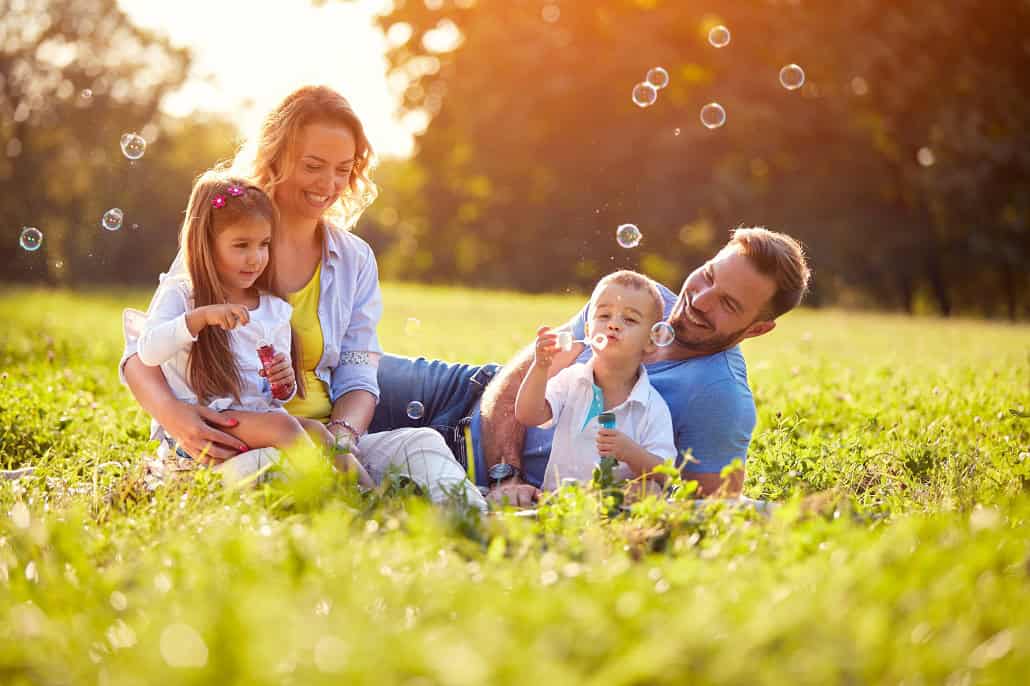 Family sitting in the grass outside