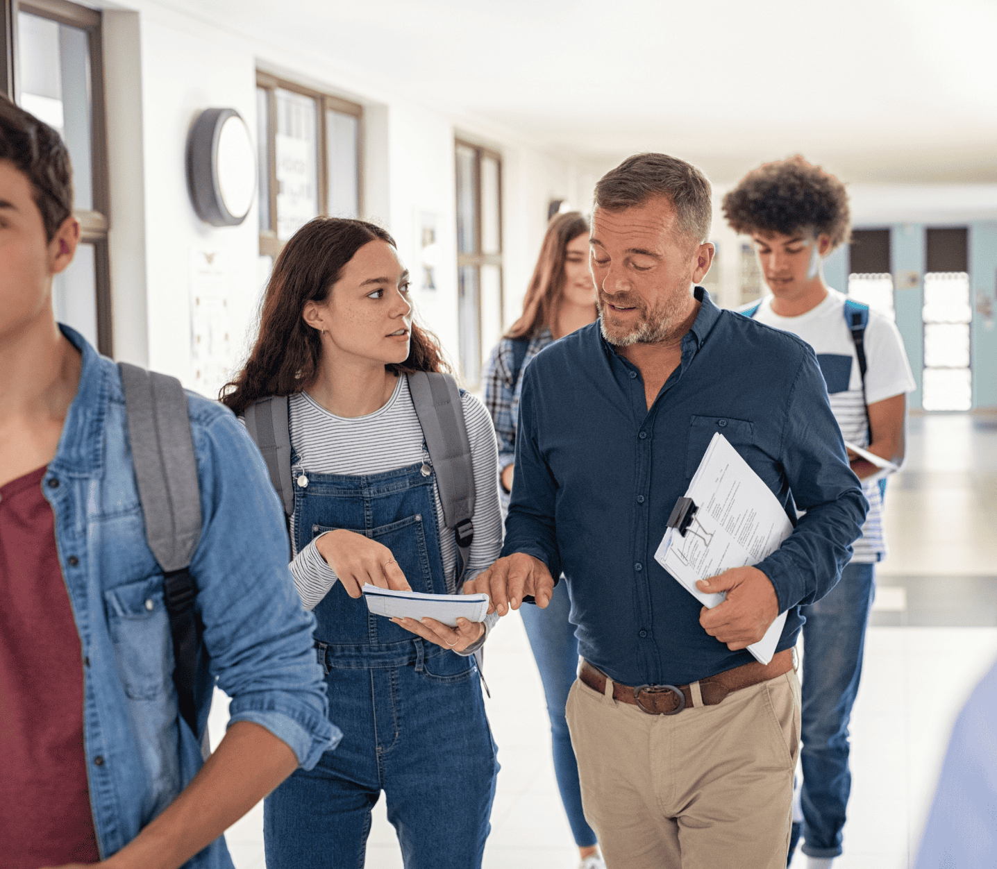 Professor talking to student in hallway