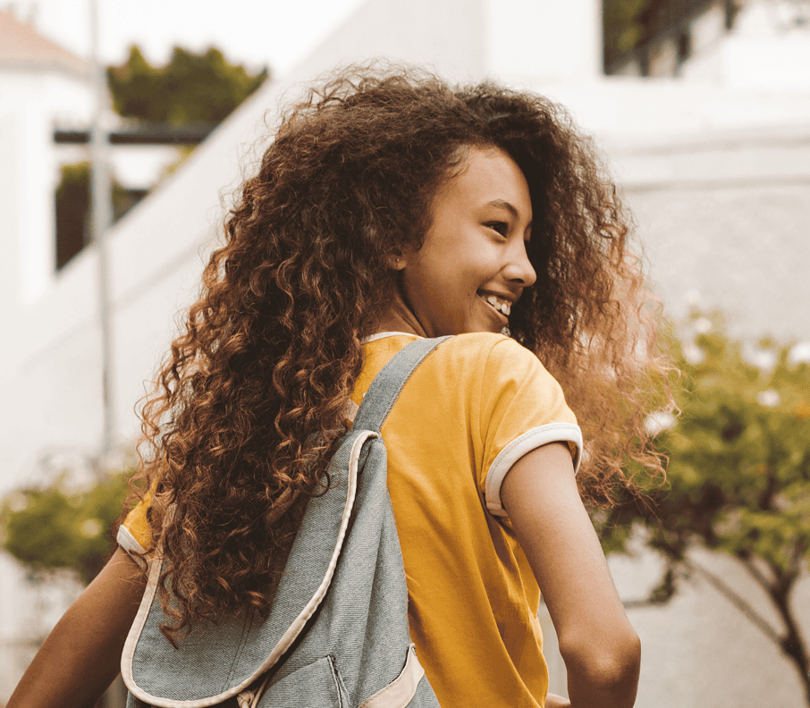 Student with curly hair and backpack