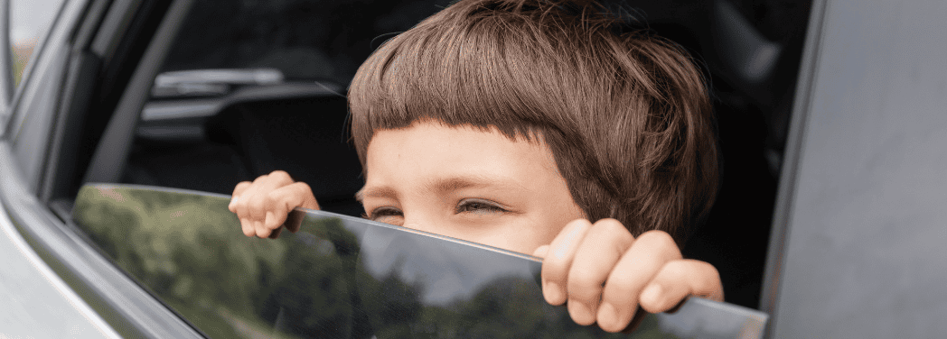 boy by the car window